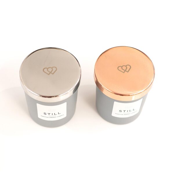 Luxury engraved rose gold tone and silver 9cl mini candle lids for a STILL positive energy candle supplied by The Universal Soul Company